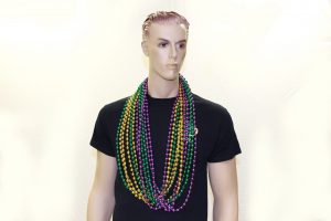 Mannequin wearing mardi gras beads