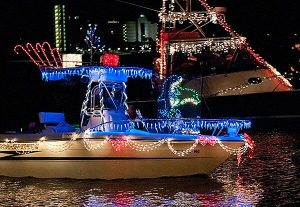 small yacht decorated with christmas lights